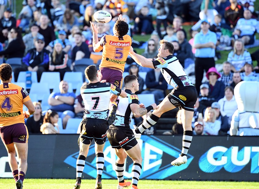 Xavier Coates leaps high to score during his NRL debut.
