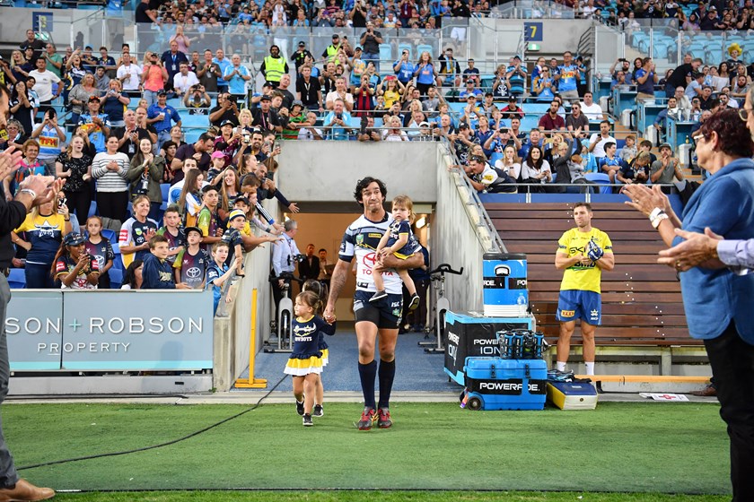 Johnathan Thurston runs out for his farewell game in 2018 with his three daughters.
