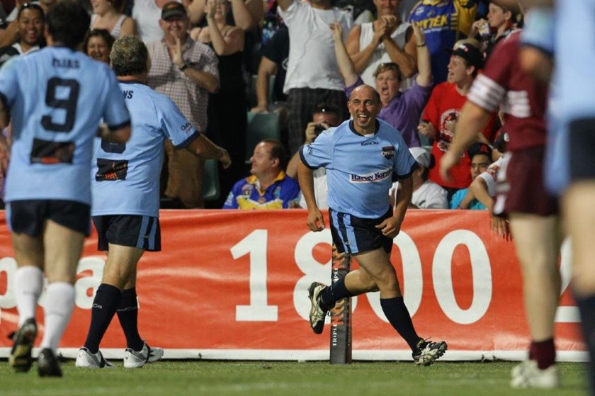 Tony Trim is walking on air after scoring a try for the Blues Legends off a Brad Fittler kick.