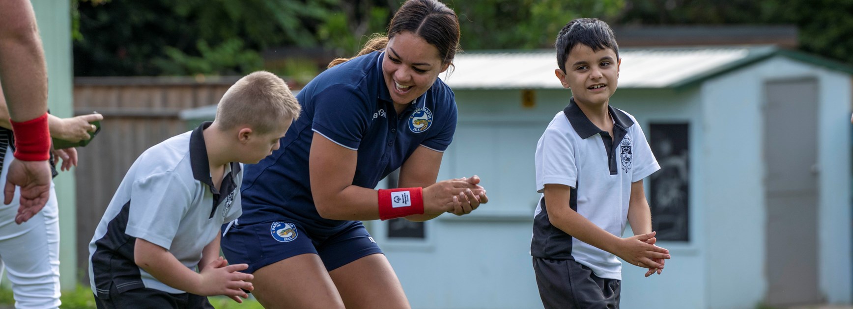 Eels NRLW player Kennedy Cherrington with St Lucy's School students. 