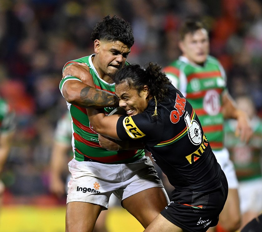 Latrell Mitchell tries to wrestle the ball from Jarome Luai