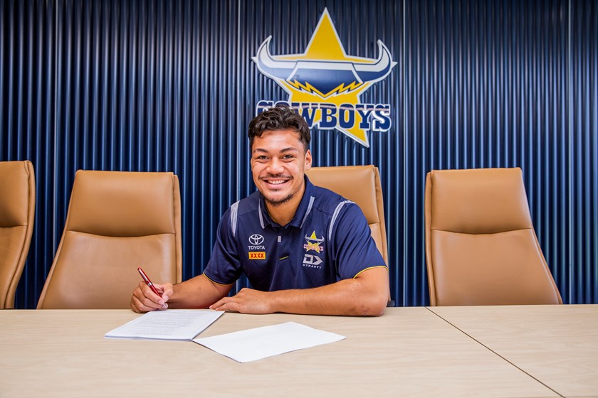 Jeremiah Nanai signs his new playing contract with the Cowboys this year.
