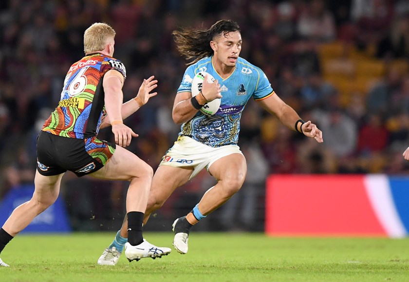 Titans skipper Tino Fa'asuamaleaui takes another carry against the Broncos.