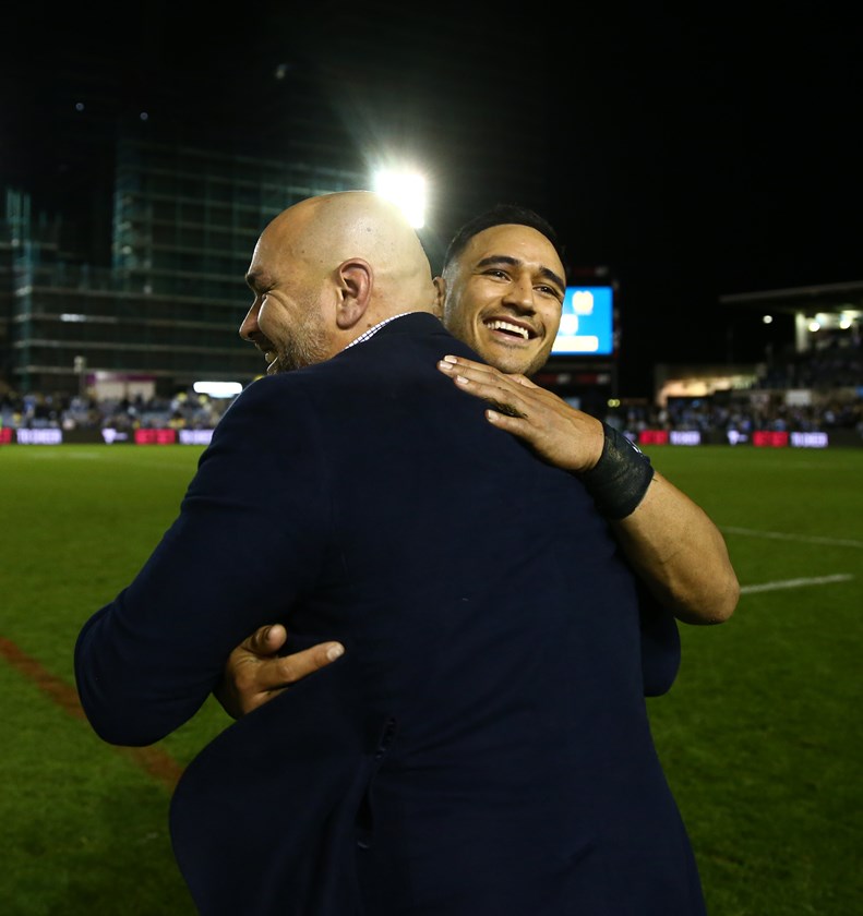 Cowboys coach Todd Payten embraces Val Holmes after Saturday night's win