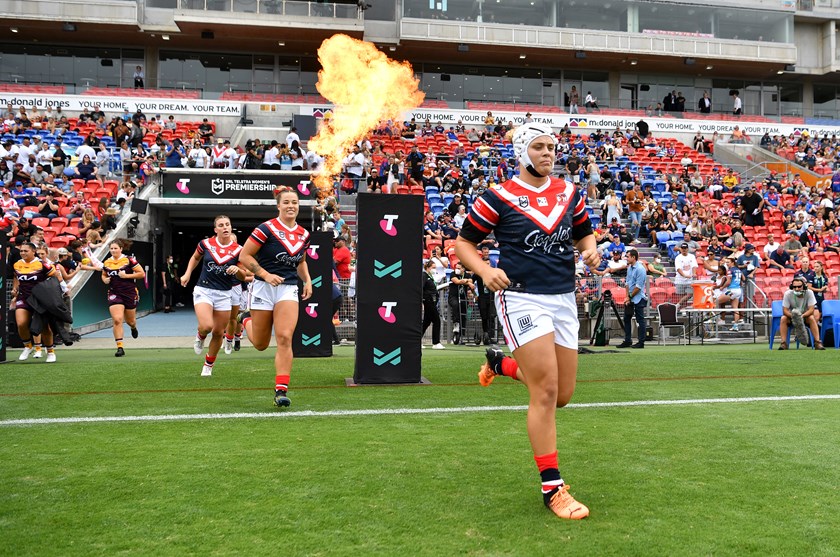 Hannah Southwell runs onto McDonald Jones Stadium in Roosters colours in February.
