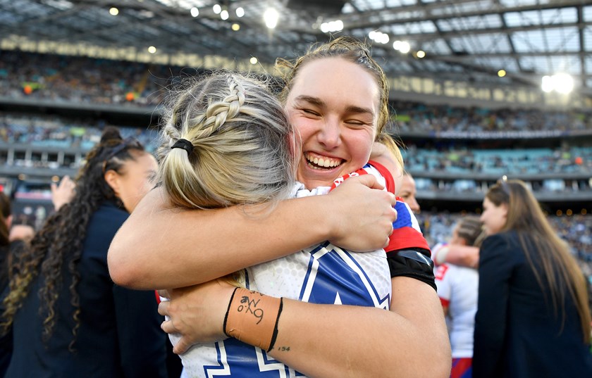 Kirra Dibb embraces fellow foundation Knights player Emma Manzelmann after Sunday's grand final win.