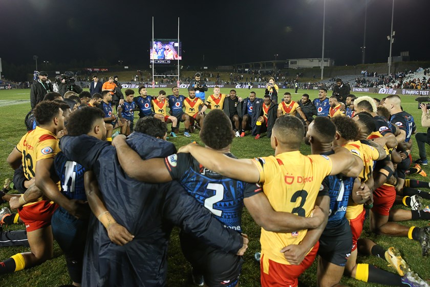 PNG and Fiji players join a prayer circle after the Pacific Test