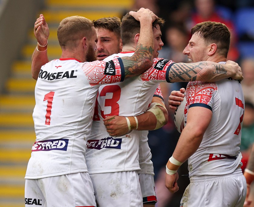 Sam Tomkins celebrates with George Williams and John Bateman