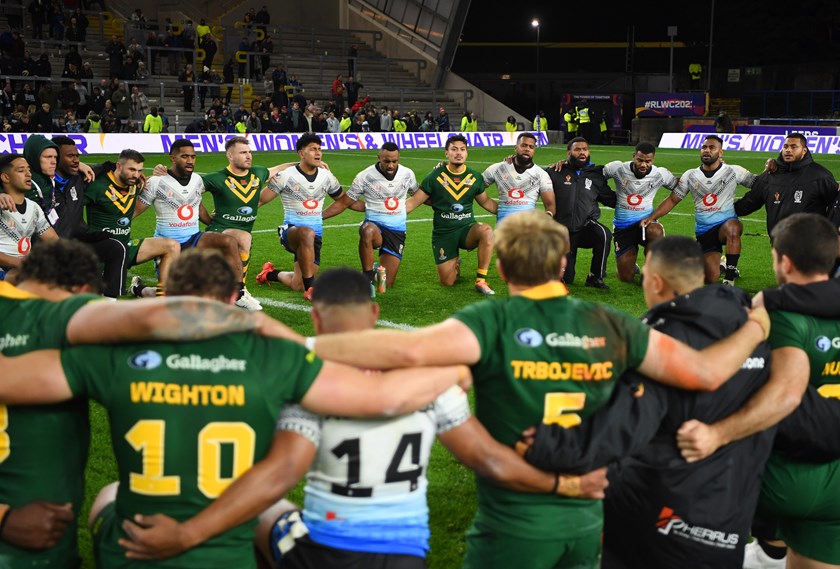 Australian and Fiji players form a prayer circle after their World Cup match