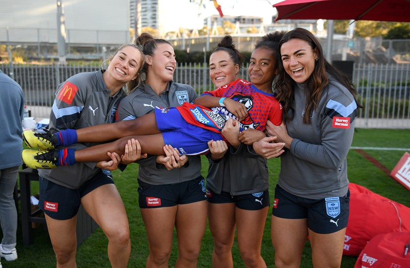 Kezie Apps, Jess Sergis, Isabelle Kelly and Millie Boyle with a fan at a Sky Blues junior clinic on Saturday.