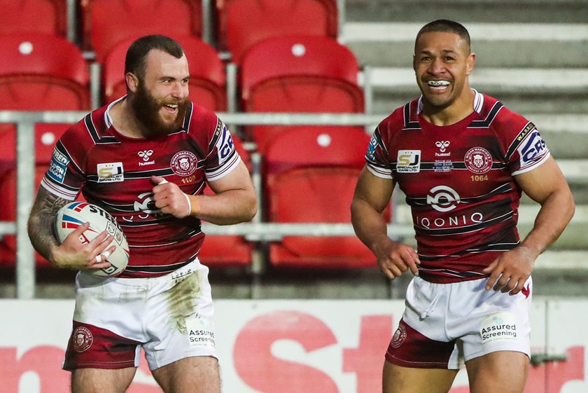 Willie Isa celebrates a Wigan try with Jake Bibby (left) during a Super League clash with Wakefield Trinity in 2021.