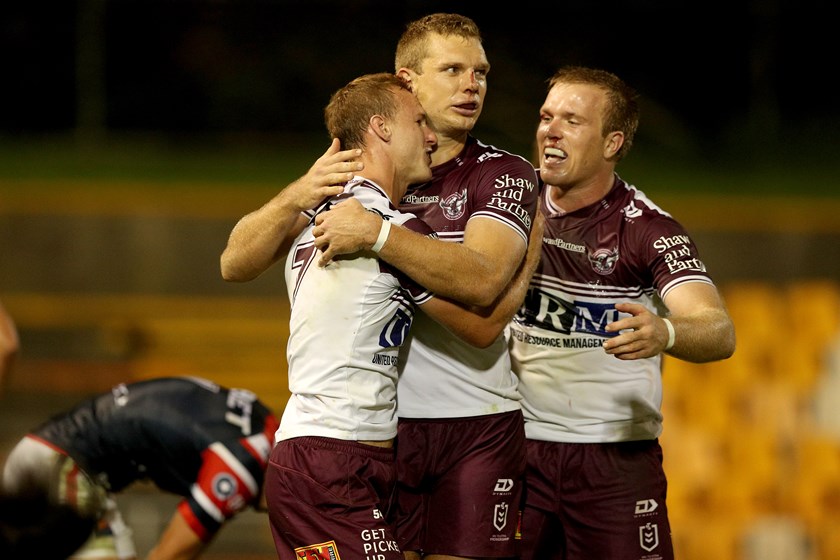 Daly Cherry-Evans, Tom Trbojevic and Jake Trbojevic celebrate a win over the Roosters in 2020.