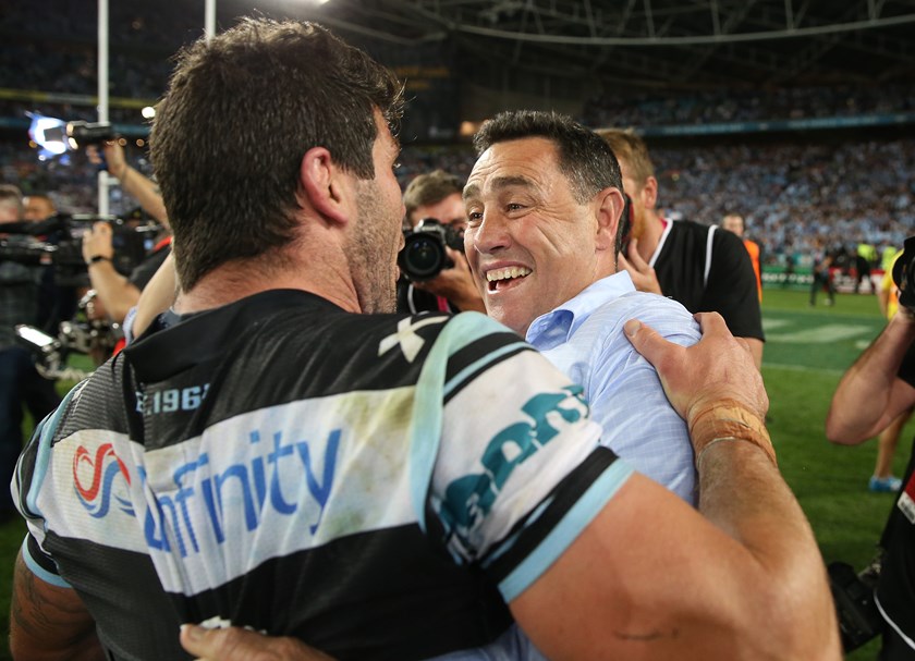 Shane Flanagan and Michael Ennis embrace after winning the 2016 grand final.