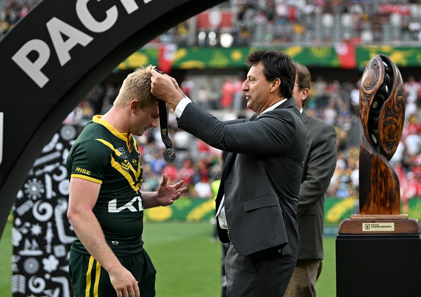 Tom Dearden receives his player-of-the-match medal from International Rugby League director and former Kangaroos captain Laurie Daley.