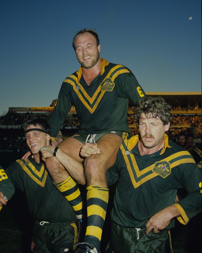 Wally Lewis is chaired from the field by Wayne Pearce and Gene Miles.