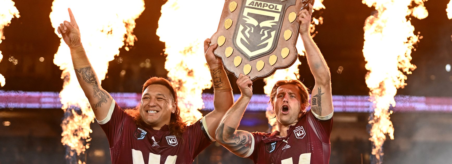 Josh Papalii holds up the State of Origin Shield with Maroons captain Cameron Munster after answering an SOS to play in the series decider