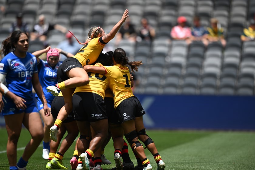 PNG Orchids players celebrate a try by captain Elsie Albert in the Pacific Cup play-off game against Samoa.