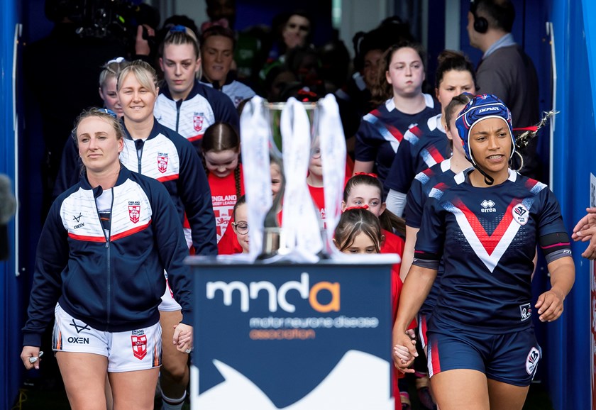 French captain Elisa Akpa (right) leads her team out against England.