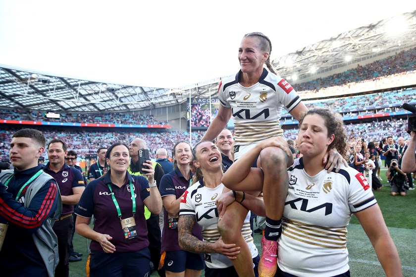Ali Brigginshaw is chaired from the field by Julia Robinson and Chelsea Lenarduzzi after the grand final.