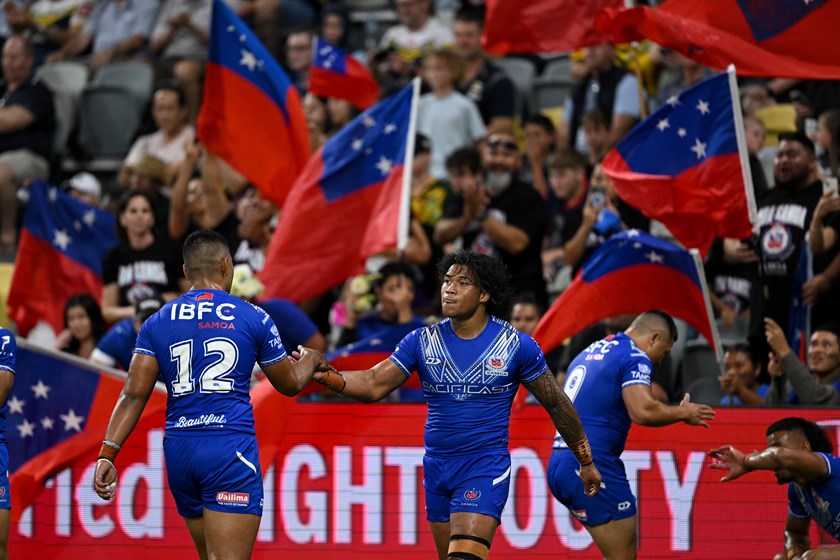 Brian To'o celebrates with Samoa team-mates after scoring a try during the Pacific Cup final.