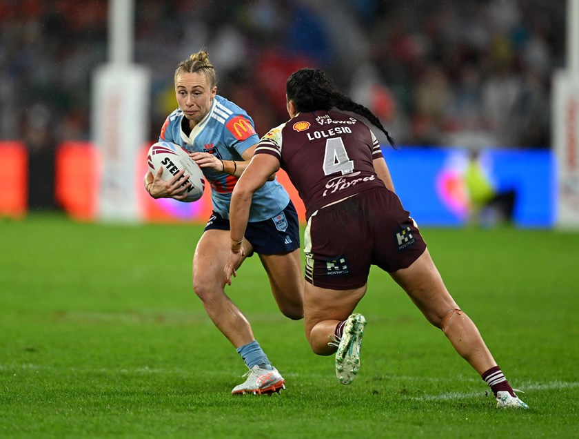 Blues fullback Abbi Church takes on Queensland centre Ivana Lolesio.