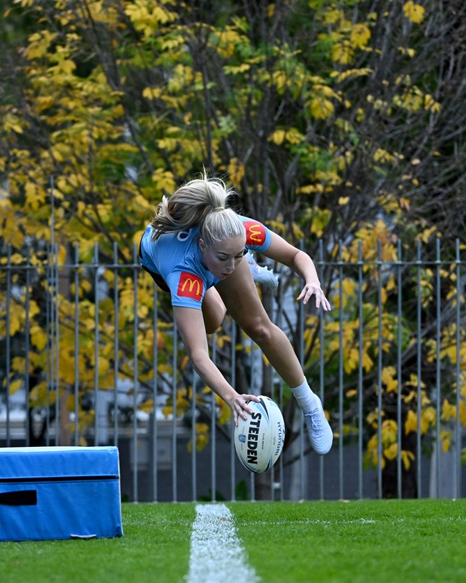 Teagan Berry practices diving to score in the corner at Blues training - but her try saving feats are unrehearsed.