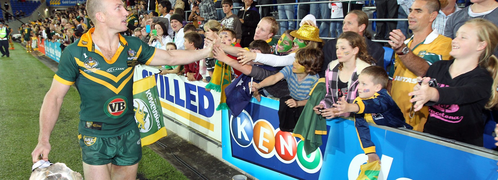 Lockyer carries the Bill Kelly Cup on a victory lap after guiding Australia to a win over the Kiwis.